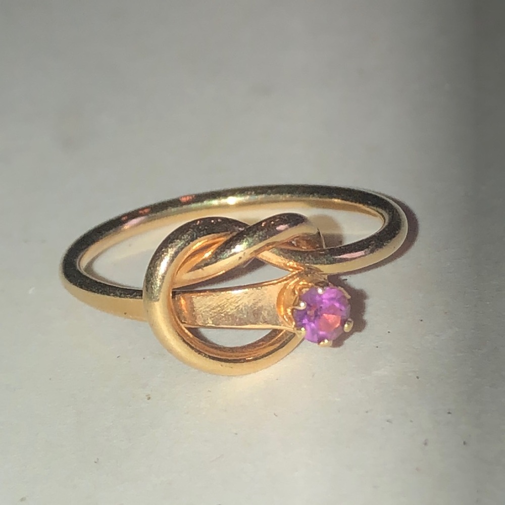 Gold Tone Knot Ring with Purple Stone